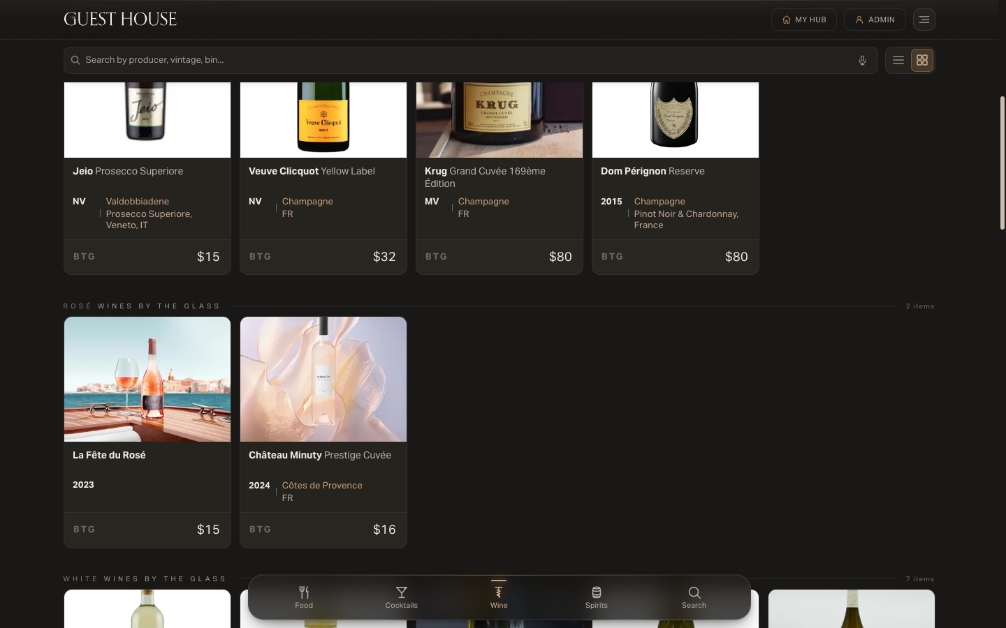 The wine knowledgebase grid: bottle photography cards organized by section